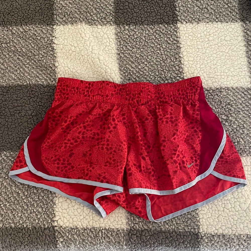 Red Nike running shorts.
